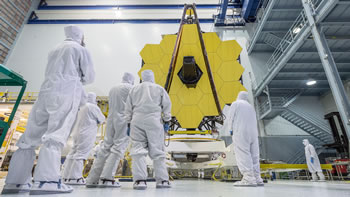 Ground level view of Web Primary Mirror in clean room with techs in foreground